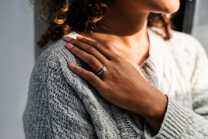 Cheerful woman with engagement ring