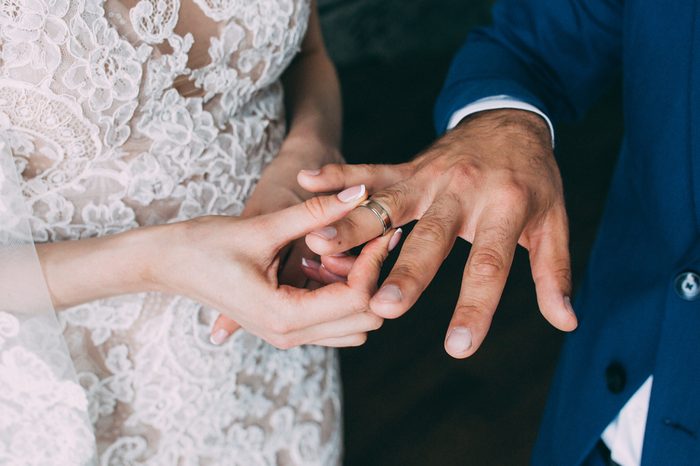 Newlyweds dress each other with gold wedding rings