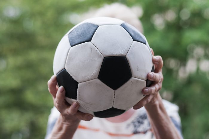 Active senior woman catches football. Close up of hands and Soccer./Senior catches Soccer