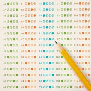 Pencil rests on a multiple-choice answer sheet, circles filled in orange, green, and blue, displaying numbers 46 to 120 in a grid pattern.