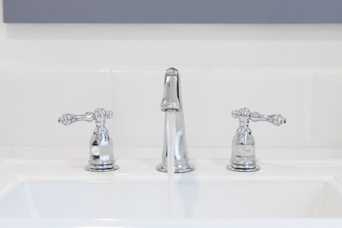 Retro style tap at washbasin pouring water