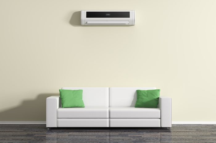 Air conditioning on the wall above the sofa.