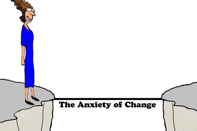 Cartoon woman stands on cliff edge, facing another cliff across a narrow, black line labeled "The Anxiety of Change."