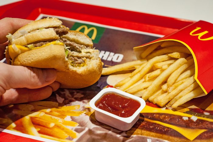 Minsk, Belarus, January 8, 2018: Man is eating at McDonald's restaurant.