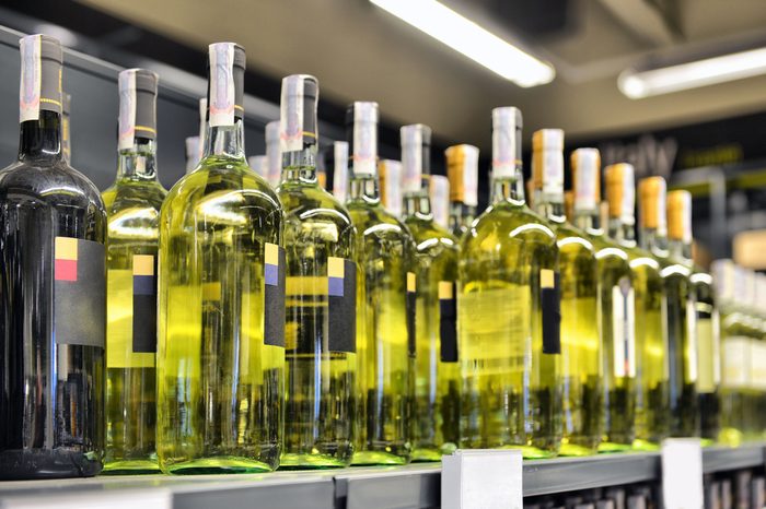 Red and white wine in bottles in wine shop