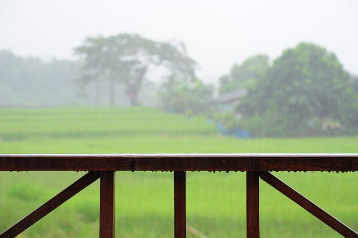Wooden rail of house terrace in raining