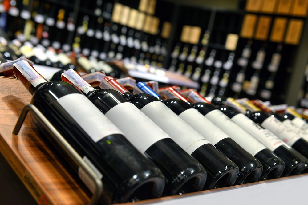 Red and white wine in bottles in wine shop