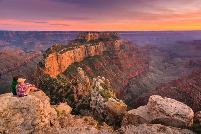 (Untouched) a group of people was sitting near the edge watching sunset at Grand Canyon National Park North Rim, USA. Grand Canyon National Park is one of the world's natural wonders.