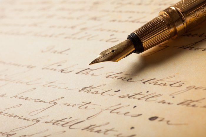 Fountain pen on an antique handwritten letter