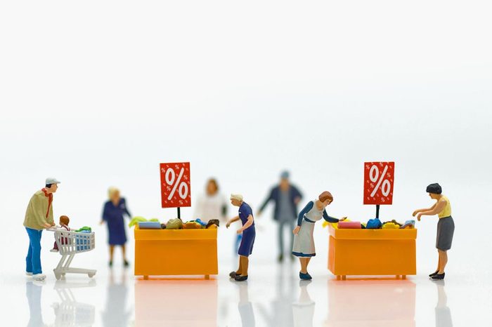 Miniature people : Shoppers with discount for shopping items using as shopping business concept.
