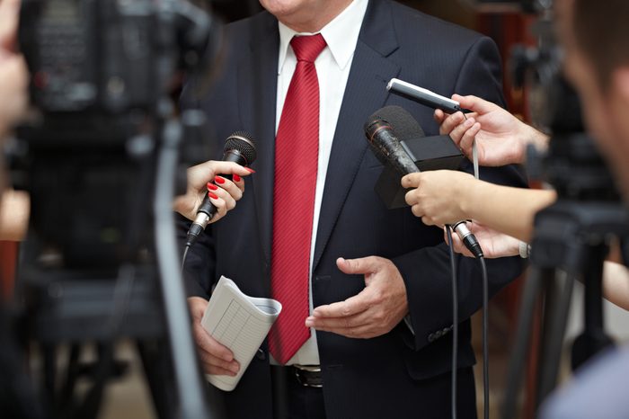 close up of conference meeting microphones and businessman