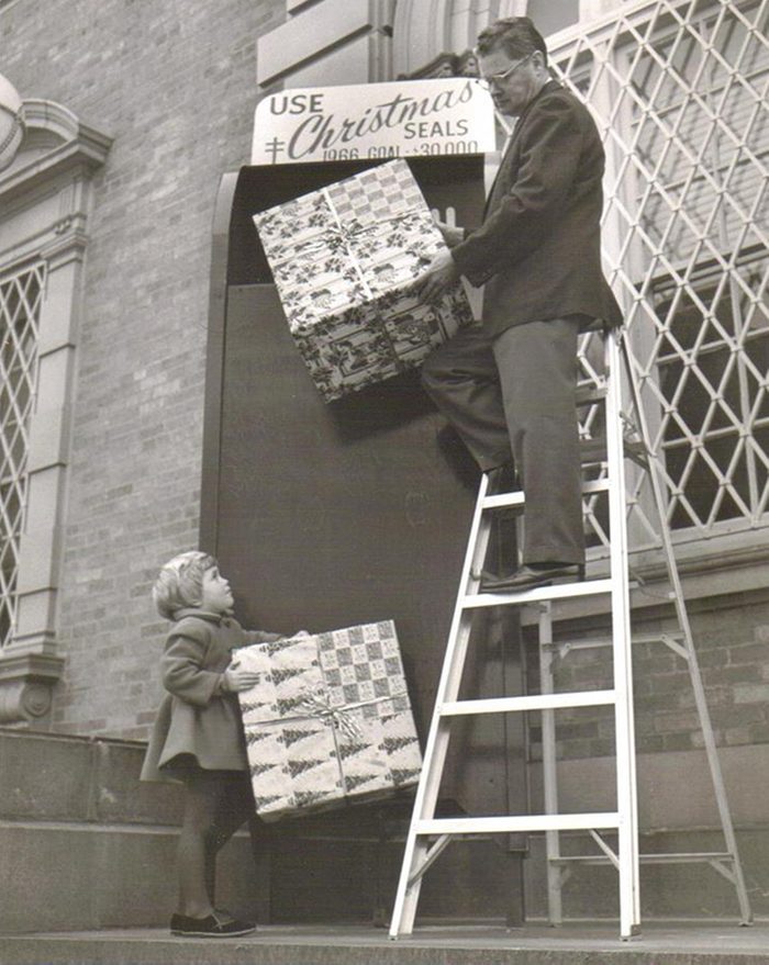 This is me at three years old during Christmastime in 1966 Modesto; CA. I wish this was in color as my coat was bright red! This was on the steps of the Modesto Post Office where I was with my mom when I saw a man lifting packages and ran up to help him and a photographer snapped this picture! Turned out he was making a display for Christmas Seals...not actually putting packages in the big box! And they ended up using it for their fundraising campaign!