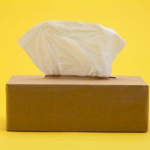 Paper tissues in brown box on yellow background