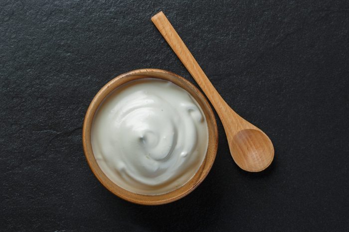 Greek yogurt on black stone background