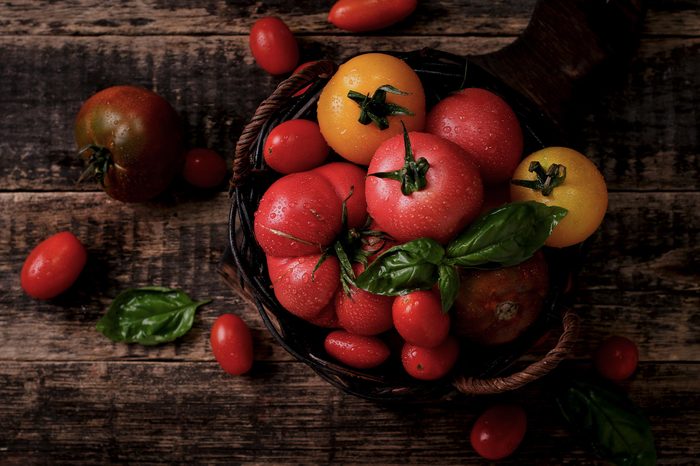 Colorful tomatoes, red , yellow , orange , green on vintage wooden background