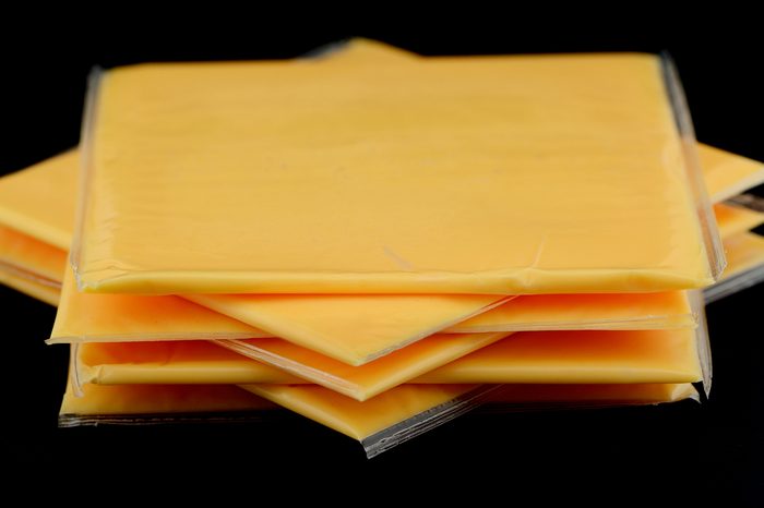 Several slices of american cheese in the studio