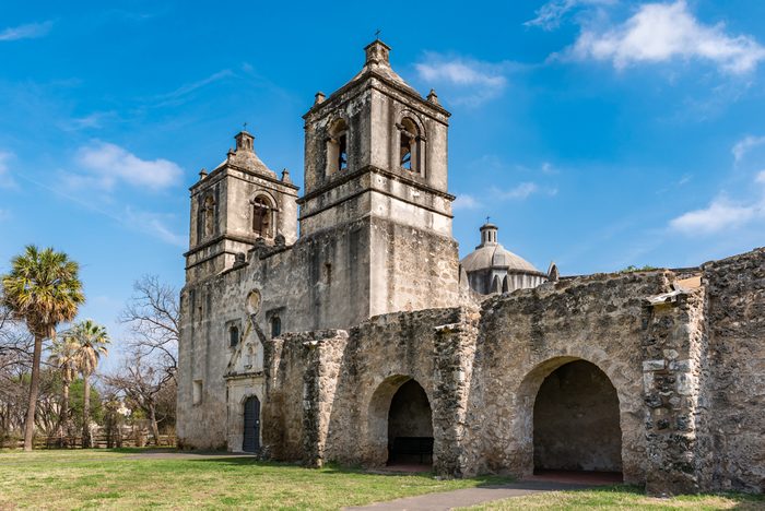 Texas Mission Concepcion side view with arches along the fortress walls church dome in the background