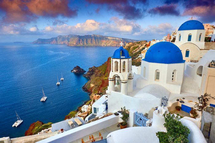 Fira town on Santorini island, Greece. Incredibly romantic sunrise on Santorini. Oia village in the morning light. Amazing sunset view with white houses. Island of lovers