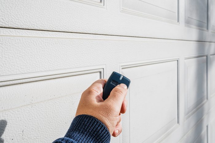 Garage door PVC. Hand use remote controller for closing and opening garage door