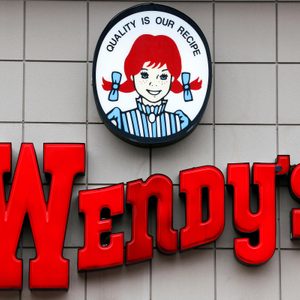 Logo features red-haired girl smiling above 