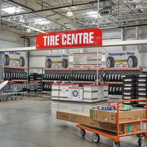 Tires displayed on racks; shopping carts nearby; 