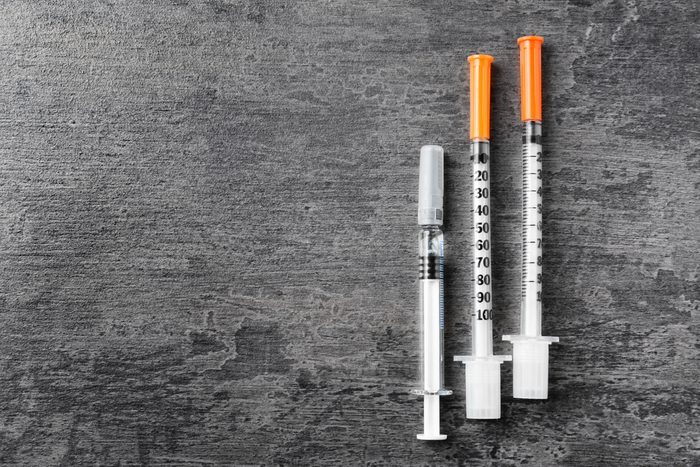 Medical syringe on grunge background. Vaccination concept