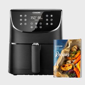 Air fryer displays 350Â°F and 88 MIN settings; recipe booklet with roasted vegetables nearby.