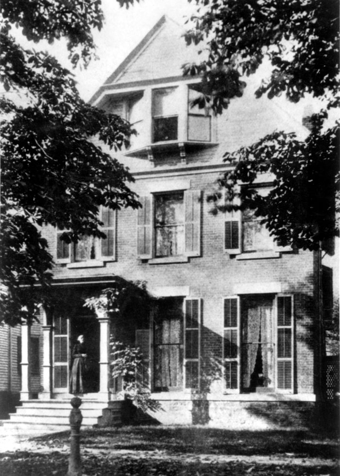 American abolitionist and suffragette Susan B Anthony (1820 - 1906) standing outside her home on 17 Madison Street, in Rochester, NY, late nineteenth century.