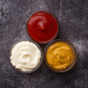 Set of different sauces: mustard, ketchup, mayonnaise. Top view