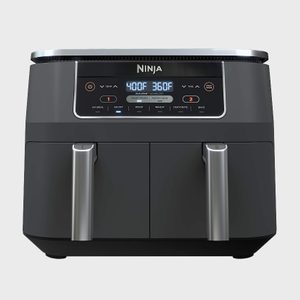 Dual-basket air fryer displays temperatures with settings for air fry, broil, roast, reheat, dehydrate, bake; set in a kitchen environment.