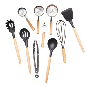 Kitchen utensils lying flat, including measuring cups labeled 1/3, 1/2, and 1 cup, pasta spoon, slotted spoon, tongs, spatula, whisk, and peeler.