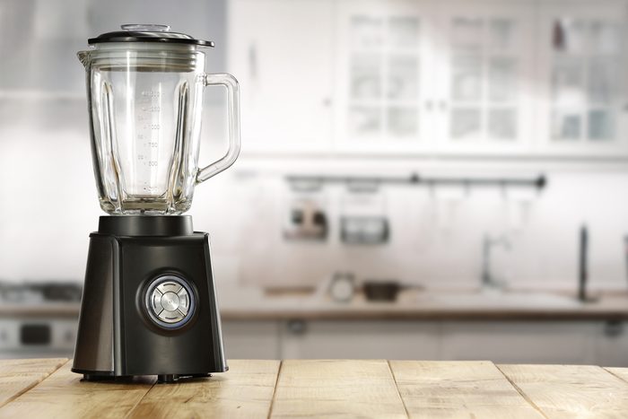 blender and wooden table in kitchen