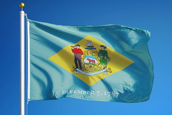 Delaware (U.S. state) flag waving against clear blue sky, close up, isolated with clipping path mask alpha channel transparency, perfect for film, news, composition