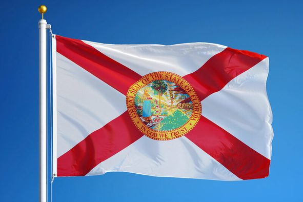Florida (U.S. state) flag waving against clear blue sky, close up, isolated with clipping path mask alpha channel transparency, perfect for film, news, composition