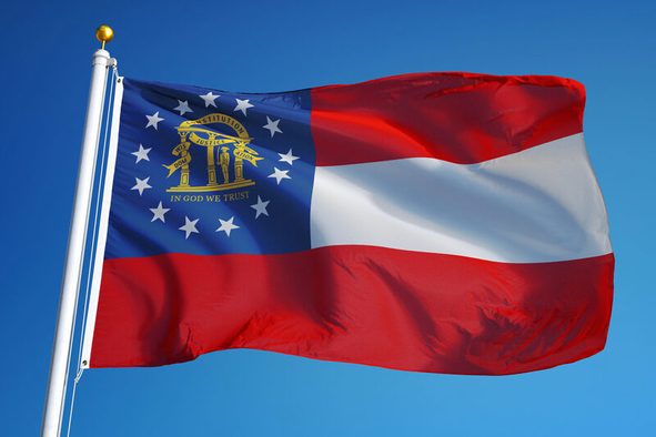 Georgia (U.S. state) flag waving against clean blue sky, close up, isolated with clipping path mask alpha channel transparency with black and white matte