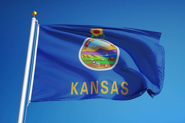 Kansas (U.S. state) flag waving against clear blue sky, close up, isolated with clipping path mask alpha channel transparency, perfect for film, news, composition