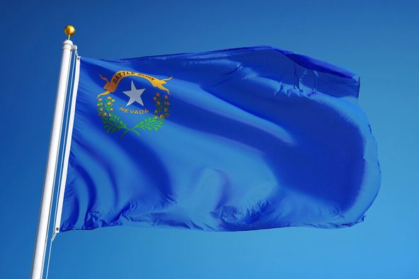 Nevada (U.S. state) flag waving against clear blue sky, close up, isolated with clipping path mask alpha channel transparency, perfect for film, news, composition