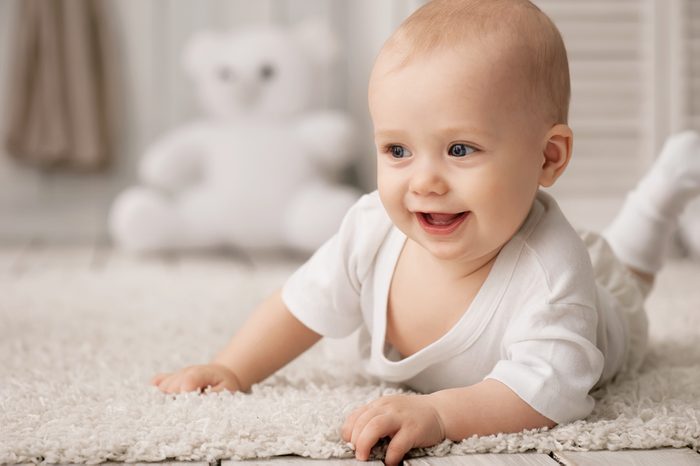 Portrait of a crawling baby on the carpet in my room