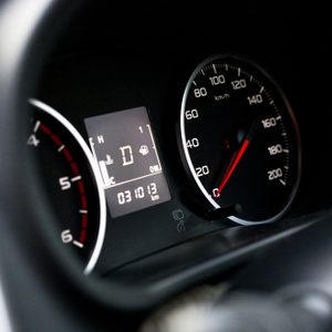 Speedometer displays 0 km/h, odometer reads 031013 km; dashboard shows oil, fuel, and temperature indicators inside a vehicle.