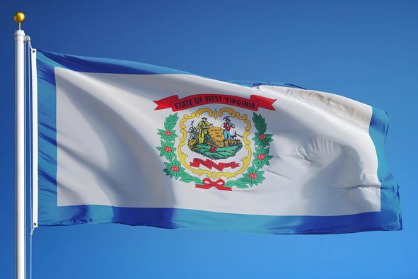 West Virginia (U.S. state) flag waving against clear blue sky, close up, isolated with clipping path mask alpha channel transparency, perfect for film, news, composition