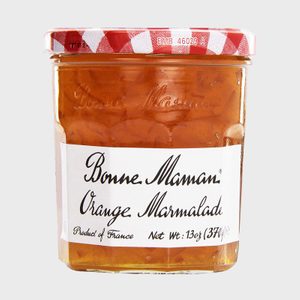 Jar containing orange marmalade, sealed with red-and-white checkered lid, labeled 