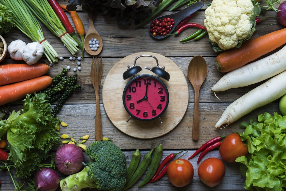 Food clock. Healthy food concept on wooden table