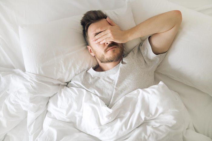 man sleep tired bed sheets