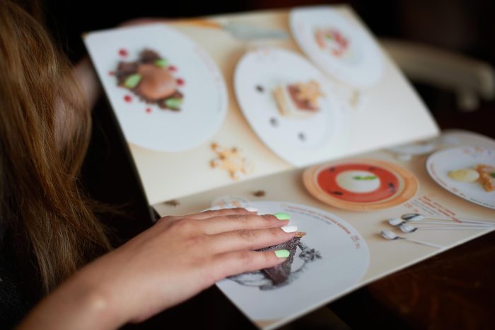 Menu card in woman's hand