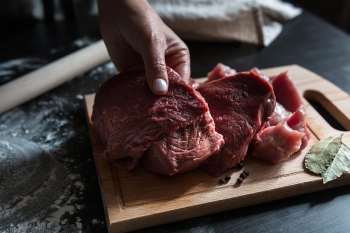 Women's hands cut beef for cooking dumplings