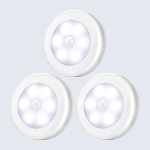 Three round, white LED lights illuminate, arranged in a triangular formation against a plain, light gray background.