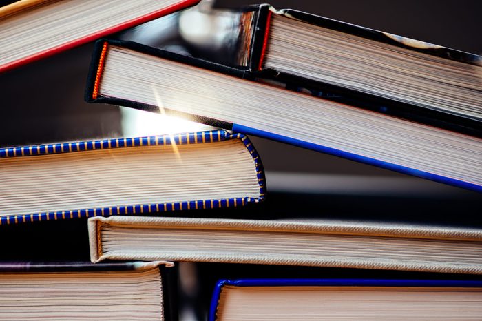 Many books piled on a stack