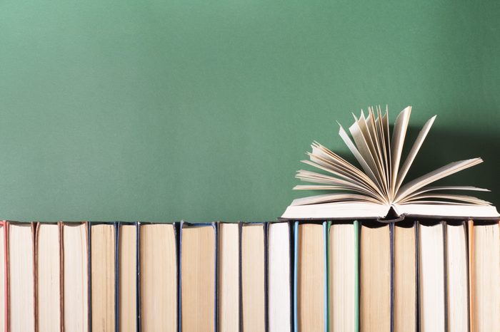 Open book, hardback books on wooden table. Education background. Back to school. Copy space for text.