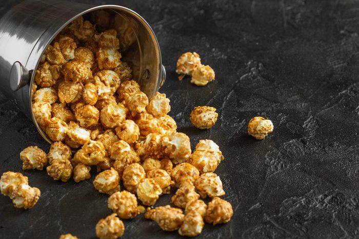 Loose popcorn on a dark background horizontally