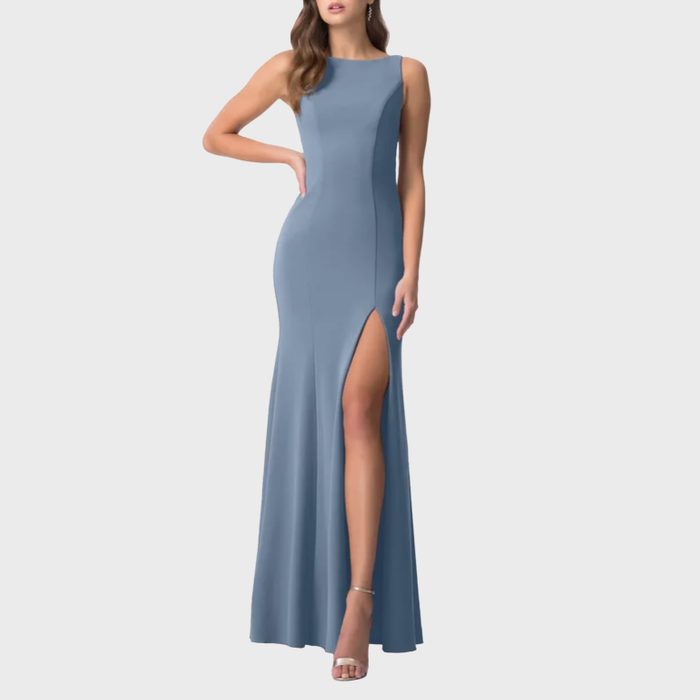 A sleeveless blue gown features a high slit, worn by a model posing against a plain background.